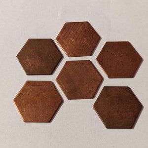 May include: Six copper hexagonal tiles with a brushed finish. The tiles are arranged in a honeycomb pattern.