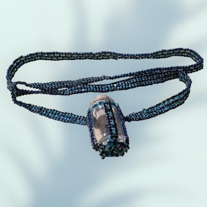 Beaded necklace with small fillable bottle. Teal and black beads in peyote stich 26 inch necklace.