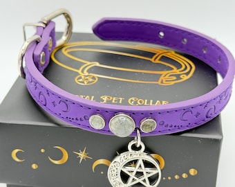 May include: Purple leather pet collar with a silver pentagram charm and clear crystal accents. The collar is embossed with moons and stars and the text "Crystal Pet Collar".