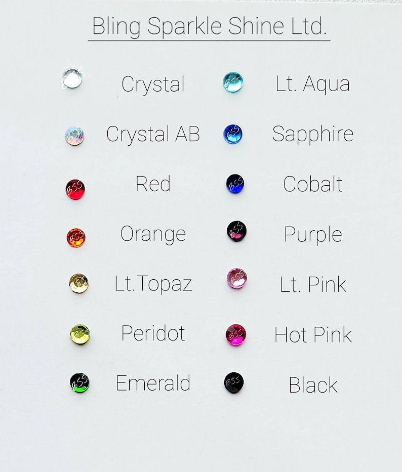 May include: A chart showing 12 different colors of rhinestones with their names. The colors are: Crystal, Lt. Aqua, Crystal AB, Sapphire, Red, Cobalt, Orange, Purple, Lt. Topaz, Lt. Pink, Peridot, Hot Pink, Emerald, and Black.