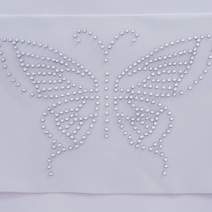 May include: A white fabric patch with a silver rhinestone butterfly design.