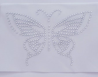 May include: A white fabric patch with a silver rhinestone butterfly design.