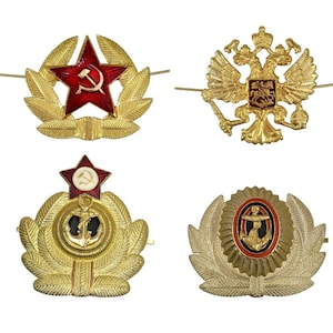 May include: Four gold-coloured military insignia with red, white, and blue accents. The insignia feature a red star with a hammer and sickle, a double-headed eagle, and two anchors.