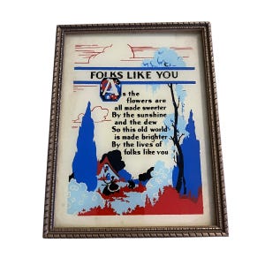 May include: Framed vintage print with the text "FOLKS LIKE YOU" and a poem. The artwork features a landscape with blue trees, red accents, and a house. The frame is a gold color.