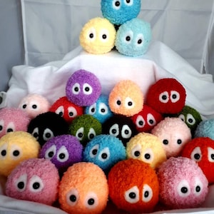 May include: A collection of colorful plush toys with googly eyes. The toys are arranged in a pyramid shape, with the largest toy at the top and the smallest toys at the bottom. The toys are made of soft, fuzzy fabric and have a variety of colors, including blue, yellow, purple, orange, red, green, and pink.