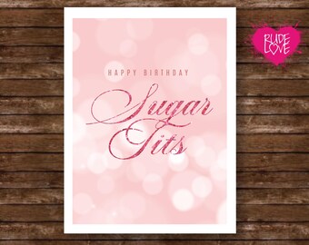 May include: A pink birthday card with the words "Happy Birthday Sugar Tits" in a glittery font. The background is a soft pink with blurred white circles. A pink heart with "Rude Love" is in the upper right corner.