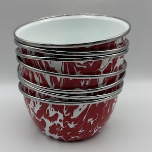 May include: A stack of four round bowls with a red and white marbled enamel finish. Each bowl features a smooth white interior and a metallic silver rim along the top edge. The exterior pattern consists of irregular red and white swirls.