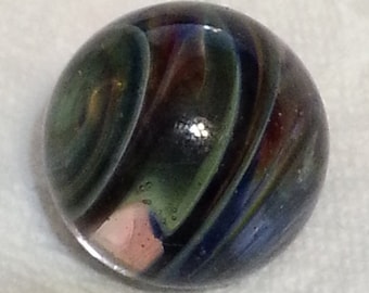 May include: A glass marble with swirling patterns of green, blue, and red. The marble has a glossy finish and a spherical shape. The colors blend together, creating a unique and eye-catching design. This collectible marble is a classic toy.