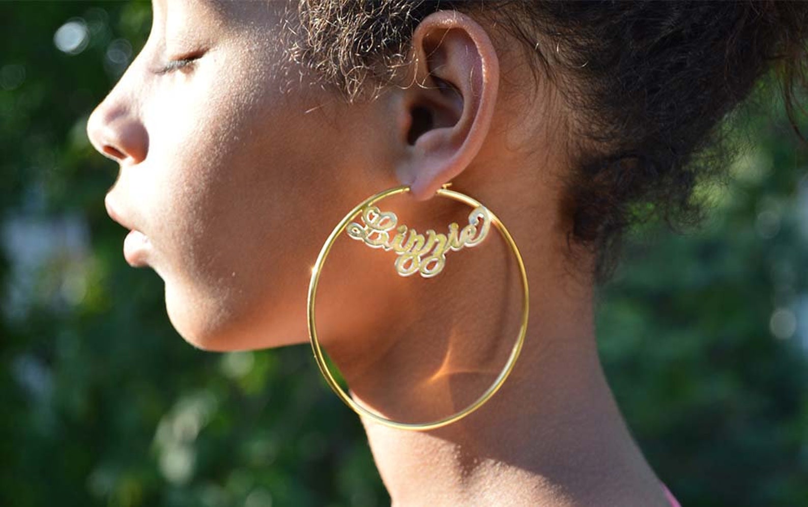 Jane domino blowing bubbles with big hoop earrings