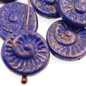 copper lustre ammonite beads in a bright navy blue