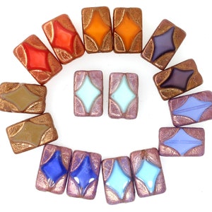 May include: Assortment of 14 rectangular glass beads with a diamond shape in the centre. The beads are in various colours, including orange, red, purple, blue, and green. The beads have a metallic gold finish.