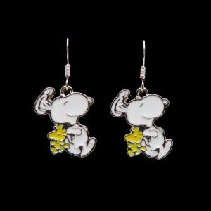 May include: A pair of silver-toned metal drop earrings featuring an enamel charm of a white dog character hugging a small yellow bird character. Each earring hangs from a standard silver-colored metal fishhook wire for pierced ears.