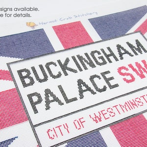 May include: A needlepoint canvas with a red, white, and blue Union Jack design. The canvas features the text "BUCKINGHAM PALACE SW1 CITY OF WESTMINSTER".