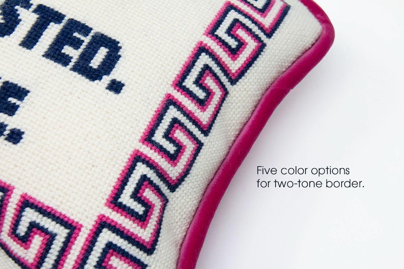 May include: White pillow with a blue and pink Greek key border and a pink leather trim. The pillow is embroidered with the text "TRUSTED." Five color options for two-tone border.
