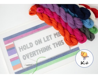 May include: A needlepoint kit featuring the phrase "Hold on let me overthink this". The kit includes colourful embroidery floss and a canvas with a pre-printed design.