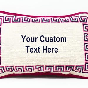 May include: A white pillow with a pink and blue Greek key border. The pillow is embroidered with the text "Your Custom Text Here".