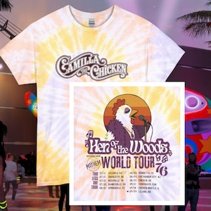 May include: A short-sleeve tie-dye t-shirt in yellow and white featuring the text Camilla the Chicken. A graphic print shows a chicken singing into a microphone with the text Hen of the Woods World Tour 76 and a list of tour dates and locations.