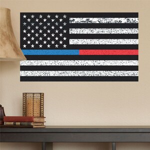 May include: A distressed American flag with a thin blue line and a thin red line. The flag is black with white stripes and white stars on a blue field.