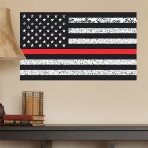 May include: A black and white American flag with a red stripe across the middle. The flag has a distressed, vintage look.