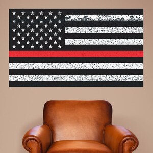 May include: A distressed American flag with a red stripe across the middle, representing the Thin Red Line, a symbol of support for firefighters. The flag is displayed on a wall above a brown leather armchair.