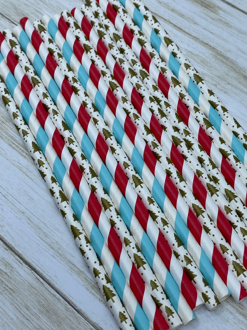 May include: A bundle of red and blue striped paper straws with a gold and white pattern of small Christmas trees.