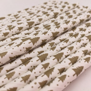 May include: A bundle of white paper straws with a gold Christmas tree pattern.