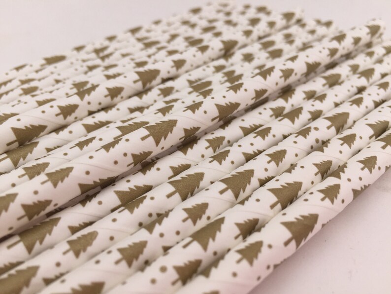 May include: A bundle of white paper straws with a gold Christmas tree pattern.