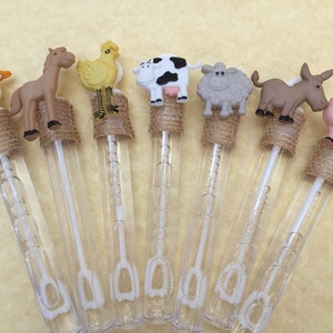 May include: Eight farm animal themed bubble wands with clear plastic tubes and brown hessian ribbon. The animal toppers include a goose, horse, chicken, cow, sheep, donkey, and pig.