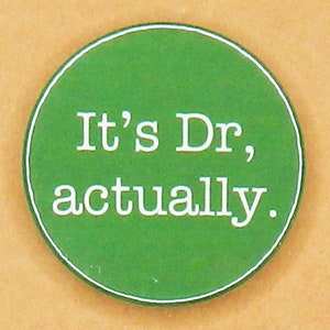 May include: A green round button with white text that reads "It's Dr, actually."