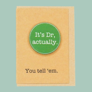 May include: A brown card with a green circle that says "It's Dr, actually." and the text "You tell 'em." below the circle.