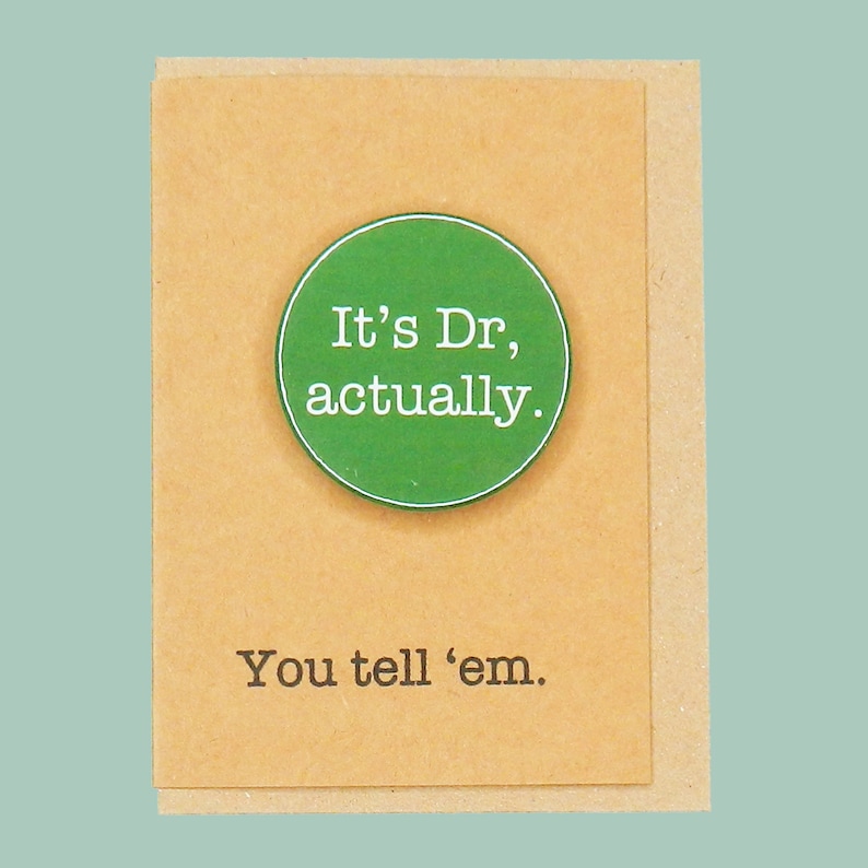 May include: A brown card with a green circle that says "It's Dr, actually." and the text "You tell 'em." below the circle.