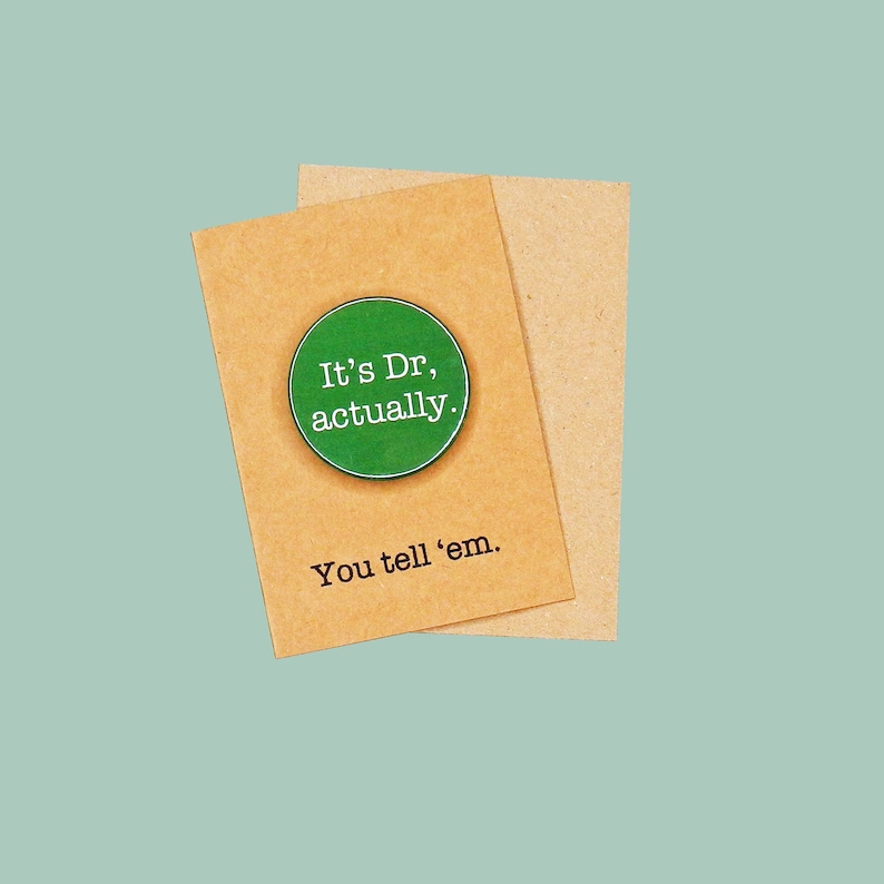 May include: A brown card with a green button that says "It's Dr., actually." and the text "You tell 'em." below the button.
