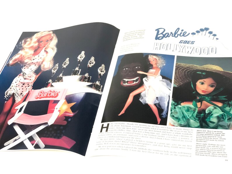 May include: A vintage magazine cover featuring Barbie dolls in a Hollywood setting. The cover features the text "Barbie Goes Hollywood" and images of Barbie dolls dressed in glamorous outfits.