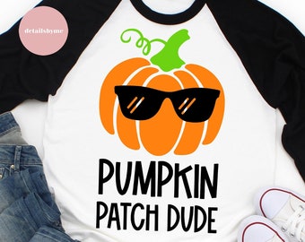 May include: A white and black baseball tee shirt with a pumpkin wearing sunglasses and the text "Pumpkin Patch Dude".