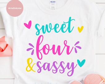 May include: White t-shirt with the text "sweet four & sassy" in colorful letters and hearts.