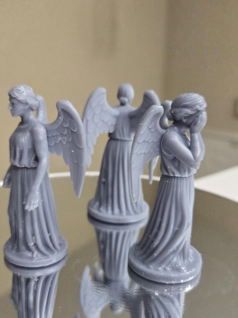 May include: A set of three ceramic mugs with a speckled, matte finish in cream, light grey, and dark grey. Each mug has a simple, minimalist design and a rounded handle.