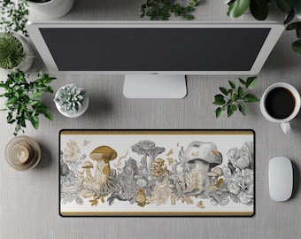 May include: A rectangular mouse mat with a detailed illustration of mushrooms, flowers, and foliage in gold, grey, and white. The design is framed with a gold border. A computer monitor, coffee cup, and mouse are also visible.