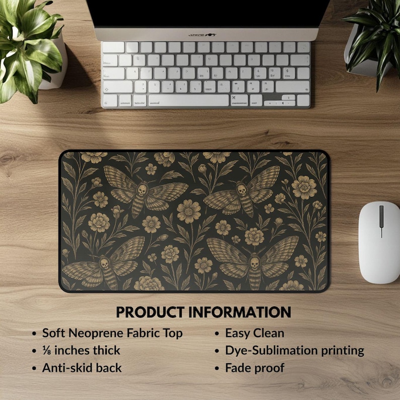 May include: A rectangular black mousepad featuring a repeating pattern of moths with skull-like markings and floral elements in gold. The mousepad is made of soft neoprene fabric, is approximately 0.3 cm thick, and has an anti-skid back.