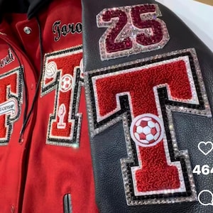 May include: Close-up of two varsity jackets. One is red with a large letter "T" and a soccer ball patch. The other is black with the number "25" and a large letter "T". Both jackets have rhinestone accents.