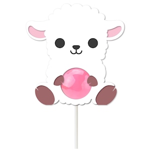 May include: A white lamb lollipop with a pink candy ball. The lamb has a cute cartoon face and brown hooves.