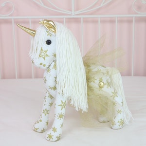 White & gold unicorn doll with gold tutu skirt and horn. 15&quot; tall.