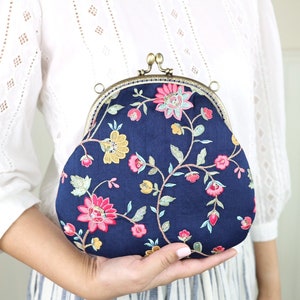 Embroidered purse with metal clasp. Navy blue and bright color flowers.