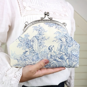Toile de Jouy fabric purse bag. Blue and white kiss lock clutch with silver frame.