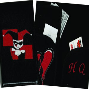 May include: Black wallet with a red heart and a Harley Quinn character embroidered on the front. The wallet has a pocket for cash and cards. The text "HQ" is embroidered on the back.