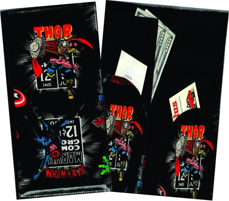 May include: Black wallet with a comic book design featuring Thor, Black Widow, and Captain America. The wallet has a pocket for cash and cards.