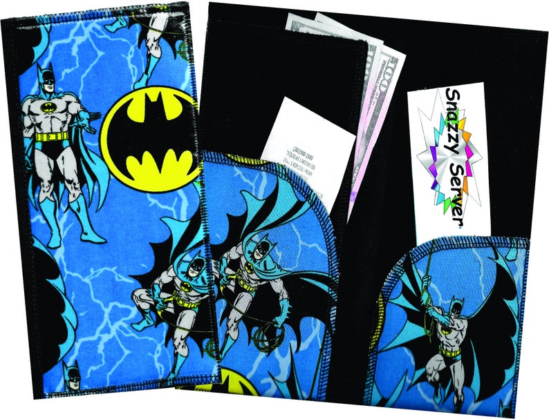 May include: A blue and black fabric wallet with a Batman theme. The wallet has a flap with a black fabric interior. The wallet has a Snazzy Server logo on the front.