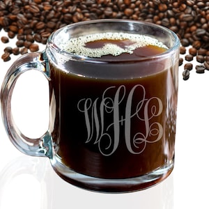 May include: A clear glass coffee mug with a black coffee inside and a monogram etched on the side. The monogram is "W+L" in a script font.