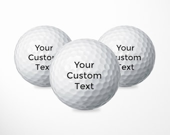 May include: Three white golf balls with black text. The text on the balls reads "Your Custom Text".