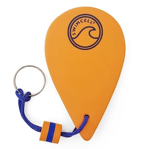 May include: An orange swim float with a blue rope and a metal ring. The float features the word "SWIMCELL" and a wave logo. A small orange and blue accent piece is attached to the rope.