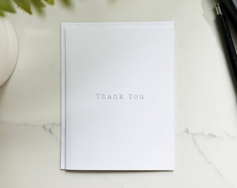 Thank you card • recycled premium matte stock, A2 folded greeting card, blank interior white envelope, simple neutral typewriter black white